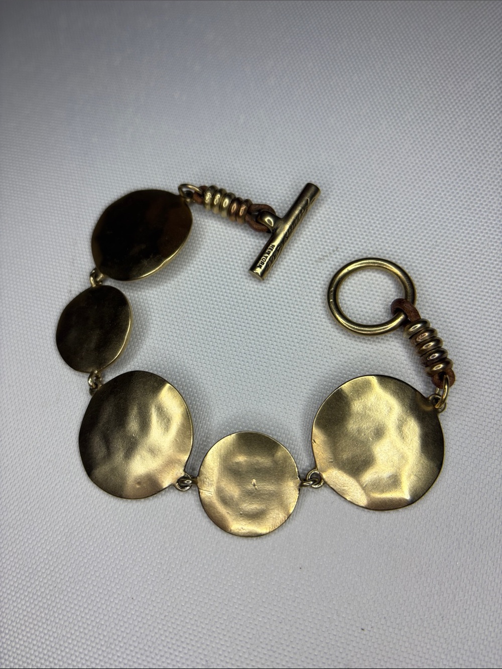 Kenneth Cole New York Goldtone coin disk style toggle bracelet